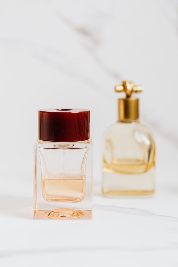 Close-up of elegant perfume bottles on a marble surface, showcasing luxury fragrances.